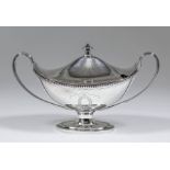 An Elizabeth II silver oval two-handled sauce tureen and cover of Neo-classical design with bead