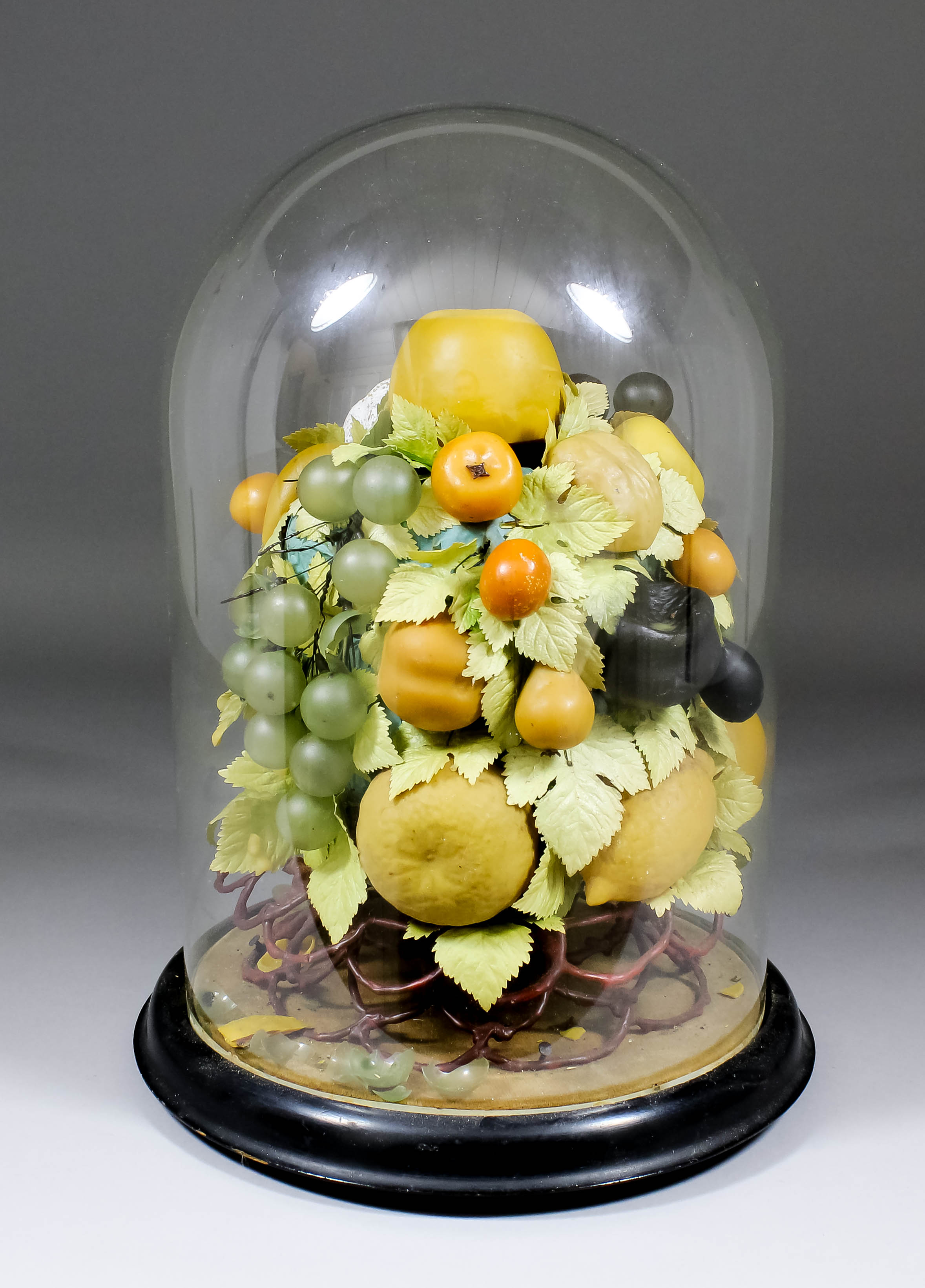 A late Victorian coloured wax and glass composition still life of fruit and leaves, 10.5ins high,