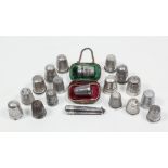 A collection of thirteen silver thimbles, various and five other metal thimbles, one contained in