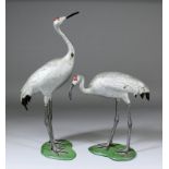 A pair of Chinese white painted metal figures of storks, 9.75ins (248mm) high and 16.125ins (