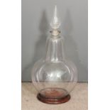 A 19th Century Chemist's clear glass carboy with bulbous body and cut-glass conical stopper, 35ins