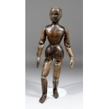 A carved and stained wood articulated lay figure, 16.5ins high (slight damage to some joints)