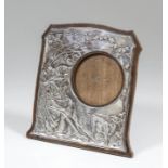 An Edward VII silver photograph frame of Art Nouveau design embossed with a seated shepherdess and