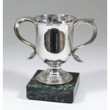 A George III plain silver two-handled cup with bell shaped body, scrolled handles with triangular