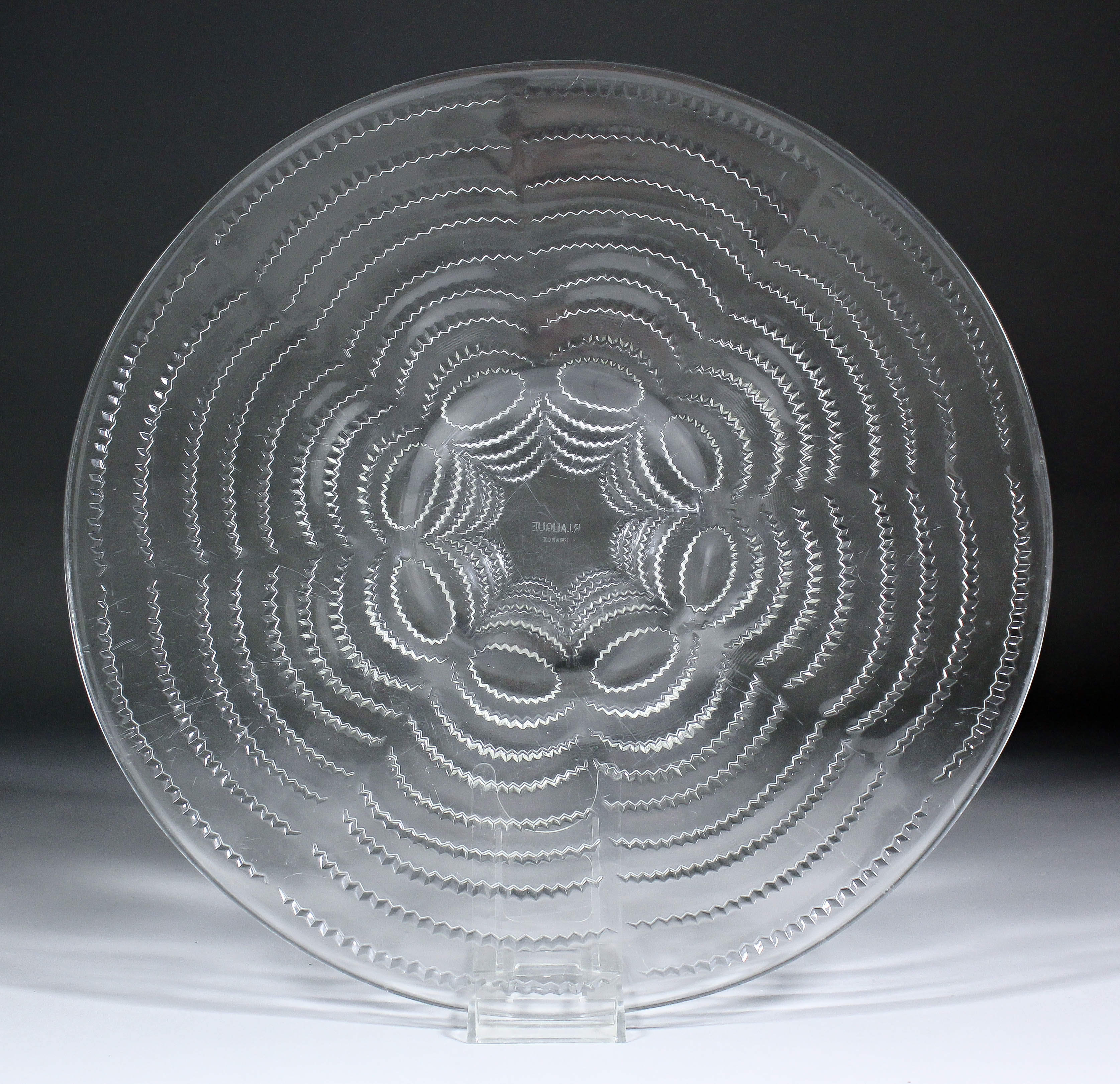 A moulded circular Lalique glass dish, 13ins diameter (etched mark to centre "R.Lalique, France")