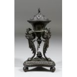 A 19th Century bronze pastel burner and lid of "Classical" form with triangular base and supported