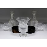 A pair of English Regency glass decanters and stoppers with hobnail and panel cutting and three