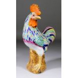 A Chinese porcelain figure of a cockerel enamelled in colours, 14ins (356mm) high