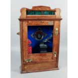 A modern replica oak cased penny-in-the-slot "Gretna-Green-The Smithy" penny flick machine with a