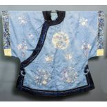 A Chinese embroidered blue silk court robe finely embroidered with dragons, exotic birds,