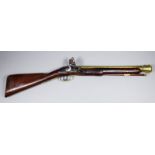 An 18th Century brass barrelled flintlock blunderbuss by Richard Wilson, the 17ins brass barrel with