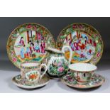 A pair of Chinese Cantonese porcelain circular plates enamelled in colours with figures at various