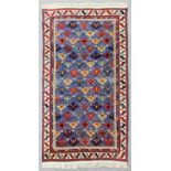 A mid 20th Century Azerbaijani Caucasian rug woven in colours with endless repeats of geometric