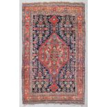 An antique Bidjar rug woven in blue, ivory and other colours with double headed medallion and