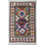 A mid 20th Century Caucasian Borchalu rug woven in colours with overlapping hooked medallions on a