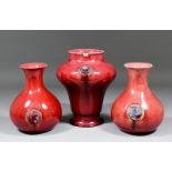 A pair of William Moorcroft red glazed pottery "Flamminian Ware" vases of baluster shape with