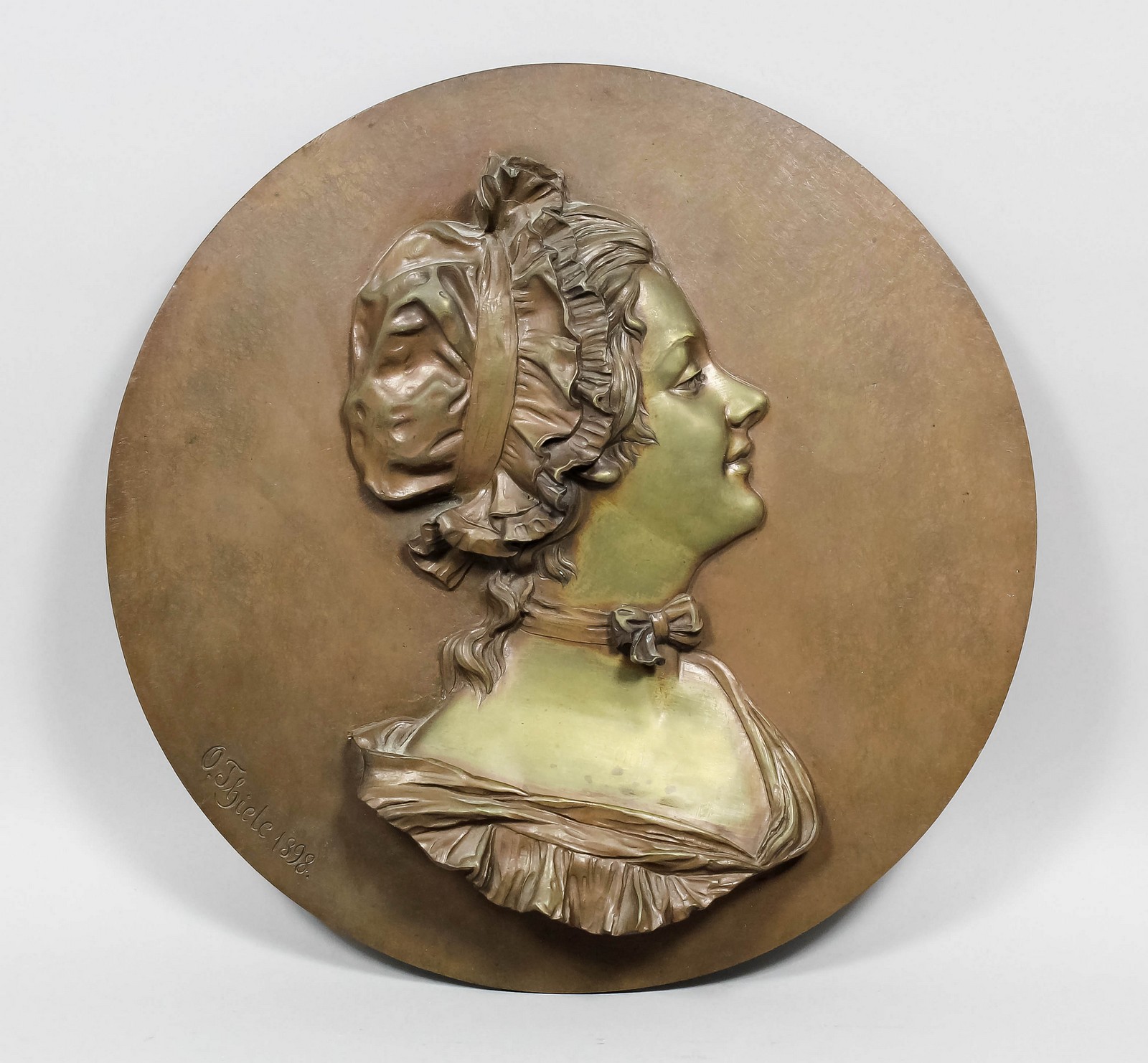 Otto Thiele (1870-1955) - Bronze circular plaque with head and shoulders bust of a young woman in