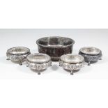 A set of four Victorian circular salts of George III design with turned-out rims and each embossed