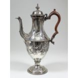 A George III silver coffee pot with embossed floral ornament, bead mounts and with fruitwood handle,