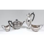 A George V silver Harlequin three piece tea service with oval partly reeded bodies, comprising -