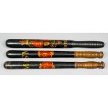 A Victorian turned wood and black finished truncheon decorated with a royal coat of arms and