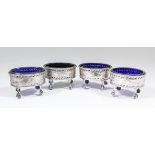 A set of four George III silver oval salts with bead mounts to rim, the sides pierced and engraved