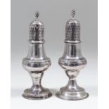 A George III silver urn pattern pepper pot, the pierced domed cover with spiral reeded final and