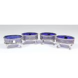 A pair of George III silver oval salts with bead mounts to rim and with pierced sides, on claw and