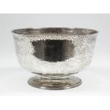 A George V silver circular bowl with hammered finish and on circular footrim, 8ins diameter x 4.