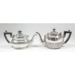 A late Victorian silver oval teapot with part spiral fluted body, ebonised angular loop handle, 5ins