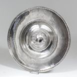 A good George V silver circular charger, the dished centre with oval shield pattern central