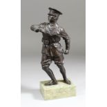 An Early 20th Century bronze figure of a First World War soldier in uniform brandishing a sword,