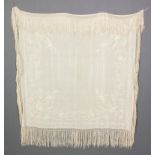 A 1920s cream silk shawl embroidered with flowering branches, 54ins square (plus fringe)