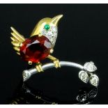 A 1940s Cartier gold and silvery coloured metal mounted garnet, diamond and emerald set "Wren"