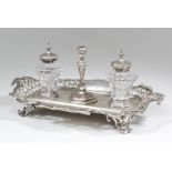 An early Victorian inkstand of scroll shaped outline and with pierced border, on pierced bracket