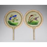 A pair of Chinese face screens each with circular silk panels, painted with birds perched on