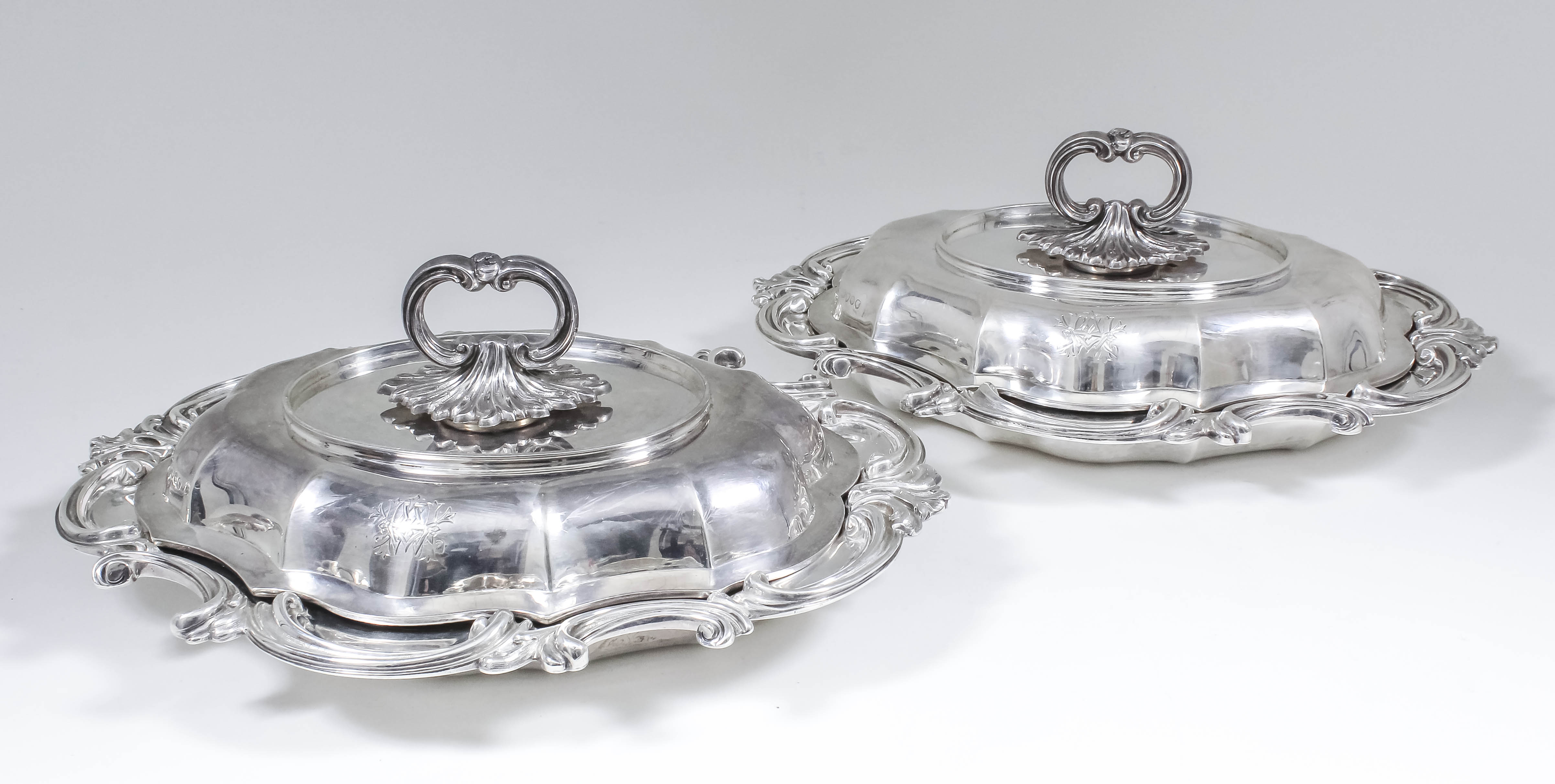 A pair of Victorian silver oval entree dishes and covers of shaped and moulded outlines with bold