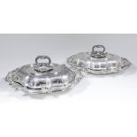 A pair of Victorian silver oval entree dishes and covers of shaped and moulded outlines with bold