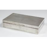 An Elizabeth II silver rectangular cigarette box with engine turned lid, 5.75ins x 3.5ins x 1.