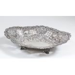 A late Victorian silver oval dish of shaped outline, pierced and cast with flowers, leaves and