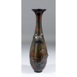 A Japanese bronze vase cast with a goose flying above lily pads, the surface finished in a brown and