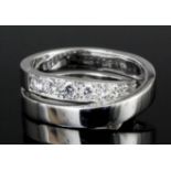 A modern Cartier 18ct white gold mounted cross-over pattern diamond ring, one band set with eleven