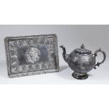 An Indian silvery metal rectangular dressing table tray, the rim with bead mounts, embossed to