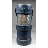 A blue canvas cylindrical shell carrier with gilt and polychrome coat of arms, stamped with Broad