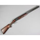 A Baikal 12 bore over and under shotgun, Serial No. E03596, the 27.5ins blued barrels with