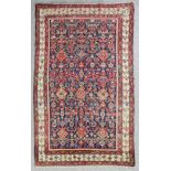 An antique Malayer long rug, woven in colours with endless stylised floral repeat on a dark blue