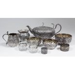 An Indian silvery metal oval teapot with serpent pattern handle and finial, the whole cast with