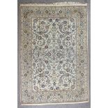 An early 20th Century Kashan carpet, woven in colours, with endless floral repeats, on an ivory