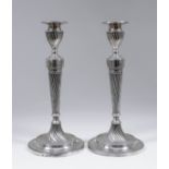 A pair of Victorian silver pillar candlesticks with bead mounts, the urn pattern sconces, tapered