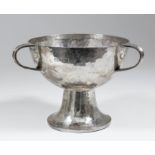 An Edward VII hammered silver three handled Tyg of Arts & Crafts design, 7ins diameter x 5ins